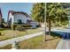 Beautiful single-Gathering home featuring a well-manicured lawn, mature trees, and a paved sidewalk at 5118 Tiber Way, St Cloud, FL 34771