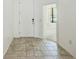 Bright foyer with tile flooring, offering a welcoming entrance and access to the home at 5118 Tiber Way, St Cloud, FL 34771