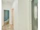 Hallway with tiled flooring, white walls, and multiple doorways leading to other rooms at 5118 Tiber Way, St Cloud, FL 34771