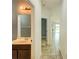 Hallway view with tile flooring, an archway, and a glimpse into the partially visible bathroom at 5118 Tiber Way, St Cloud, FL 34771
