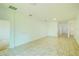 Open-concept living room featuring neutral tile flooring and natural light at 5118 Tiber Way, St Cloud, FL 34771