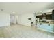 Spacious living space with an open floor plan, featuring a kitchen with granite countertops at 5118 Tiber Way, St Cloud, FL 34771