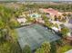 Aerial view of the tennis courts and clubhouse with lush landscaping at 523 Shell Creek St, Poinciana, FL 34759