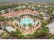Aerial view of community pool and clubhouse surrounded by lush landscaping at 523 Shell Creek St, Poinciana, FL 34759