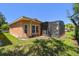 View of the home's backyard with a screened in lanai and mature landscaping at 523 Shell Creek St, Poinciana, FL 34759