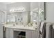 Well-lit bathroom featuring dual sinks, a spacious vanity, and a walk-in shower at 523 Shell Creek St, Poinciana, FL 34759