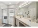 Bright bathroom with a large mirror, walk-in shower, and ample counter space at 523 Shell Creek St, Poinciana, FL 34759