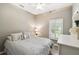 Cozy bedroom with neutral walls, fan, plantation shutters, and natural light at 523 Shell Creek St, Poinciana, FL 34759