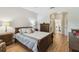 Comfortable bedroom with wood furniture, soft lighting, and an arched doorway to the ensuite at 523 Shell Creek St, Poinciana, FL 34759