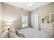 Bright bedroom featuring a window with shutters, neutral wall paint, and wood flooring at 523 Shell Creek St, Poinciana, FL 34759