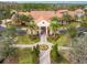 Beautiful aerial view of the community clubhouse entrance with palm trees and well-maintained landscaping at 523 Shell Creek St, Poinciana, FL 34759