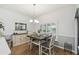 Charming dining space with hardwood floors, a rustic sideboard, and a modern chandelier at 523 Shell Creek St, Poinciana, FL 34759
