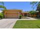 Charming single-story home with a well-manicured lawn and two-car garage at 523 Shell Creek St, Poinciana, FL 34759