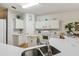 Bright kitchen featuring white cabinets, countertops and a modern sink at 523 Shell Creek St, Poinciana, FL 34759