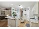 Open-concept kitchen with island and view to the living room at 523 Shell Creek St, Poinciana, FL 34759