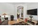 Comfortable living room with hardwood floors, arched doorway, and recessed lighting at 523 Shell Creek St, Poinciana, FL 34759