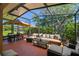 Relaxing screened patio featuring comfortable seating, a dining set, and lush greenery views at 523 Shell Creek St, Poinciana, FL 34759