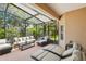Serene screened patio with lounge chairs, a comfortable sofa, and lush backyard views at 523 Shell Creek St, Poinciana, FL 34759