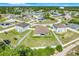 Overhead neighborhood shot highlighting fenced yards and home spacing in a residential community with green trees and blue skies at 53 Zinnia E Ln, Kissimmee, FL 34759