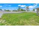 A large backyard featuring lush grass and a tall white fence at 53 Zinnia E Ln, Kissimmee, FL 34759