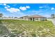 Large backyard with grass and a newer white fence at 53 Zinnia E Ln, Kissimmee, FL 34759