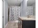 This bathroom features a granite countertop, tiled floors, and a shower with a tub at 53 Zinnia E Ln, Kissimmee, FL 34759