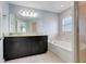 Bathroom features a double vanity, tub, and a walk-in shower at 53 Zinnia E Ln, Kissimmee, FL 34759