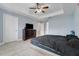 Bright bedroom features tray ceilings, tile floor and neutral wall color at 53 Zinnia E Ln, Kissimmee, FL 34759