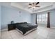 Spacious bedroom with tray ceiling, plantation shutters, and tiled floor at 53 Zinnia E Ln, Kissimmee, FL 34759