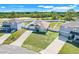 Charming gray home features a long driveway, a two-car garage, and a lush front lawn under a clear blue sky at 53 Zinnia E Ln, Kissimmee, FL 34759