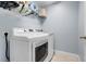 This laundry room features new appliances and an upper shelf for detergent and hangers at 53 Zinnia E Ln, Kissimmee, FL 34759