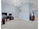 Bright open living space with tile flooring, tall ceilings, and a functional office setup at 53 Zinnia E Ln, Kissimmee, FL 34759