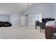 Bright living room features neutral walls, large windows, and comfortable dark furniture at 53 Zinnia E Ln, Kissimmee, FL 34759