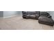 Spacious living room with tile flooring, plush leather seating, and neutral wall paint at 53 Zinnia E Ln, Kissimmee, FL 34759