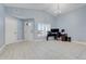 Open-concept living space featuring tile floors, high ceilings, and an office setup at 53 Zinnia E Ln, Kissimmee, FL 34759
