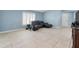 Bright living room features neutral walls, large windows, and comfortable dark furniture at 53 Zinnia E Ln, Kissimmee, FL 34759