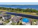 Scenic aerial shot of a home near a large lake, featuring a backyard pool and lush greenery at 5759 Marsh Landing Dr, Winter Haven, FL 33881