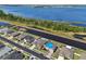 Aerial view of homes along canal, highlighting a house with a backyard pool and the lake in the distance at 5759 Marsh Landing Dr, Winter Haven, FL 33881