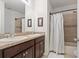 Well-lit bathroom featuring double vanity sinks and a bathtub with shower, providing a convenient space at 5759 Marsh Landing Dr, Winter Haven, FL 33881