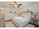Comfortable bedroom features a queen bed, wood floors, and a ceiling fan at 5759 Marsh Landing Dr, Winter Haven, FL 33881