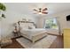 Serene bedroom with a plush rug, decorative ceiling fan, and abundant natural light at 5759 Marsh Landing Dr, Winter Haven, FL 33881