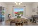 Bright dining area with a pool view, wood table, and neutral color scheme at 5759 Marsh Landing Dr, Winter Haven, FL 33881