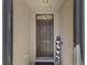 Inviting front door with a dark finish, transom window, and a charming HOME sign at 5759 Marsh Landing Dr, Winter Haven, FL 33881