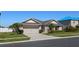 Beautiful single-story home with a manicured lawn, mature landscaping, and a convenient two-car garage at 5759 Marsh Landing Dr, Winter Haven, FL 33881