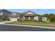 Charming single-story home with a well-manicured lawn, mature landscaping, and an attached two-car garage at 5759 Marsh Landing Dr, Winter Haven, FL 33881
