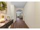 Bright hallway with elegant dark wood flooring and an arched doorway leading to the living area at 5759 Marsh Landing Dr, Winter Haven, FL 33881