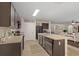 Well-equipped kitchen with ample counter space, a kitchen island, modern appliances, and dark wood cabinetry at 5759 Marsh Landing Dr, Winter Haven, FL 33881
