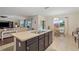 Modern kitchen with granite counters, an island with a double sink, and seamless access to the living area at 5759 Marsh Landing Dr, Winter Haven, FL 33881