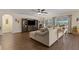 Spacious living room with comfortable seating, a decorative entertainment center, and hardwood floors at 5759 Marsh Landing Dr, Winter Haven, FL 33881