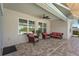 Inviting covered patio with cozy seating, ceiling fans, and a serene view of the lush landscaping at 5759 Marsh Landing Dr, Winter Haven, FL 33881